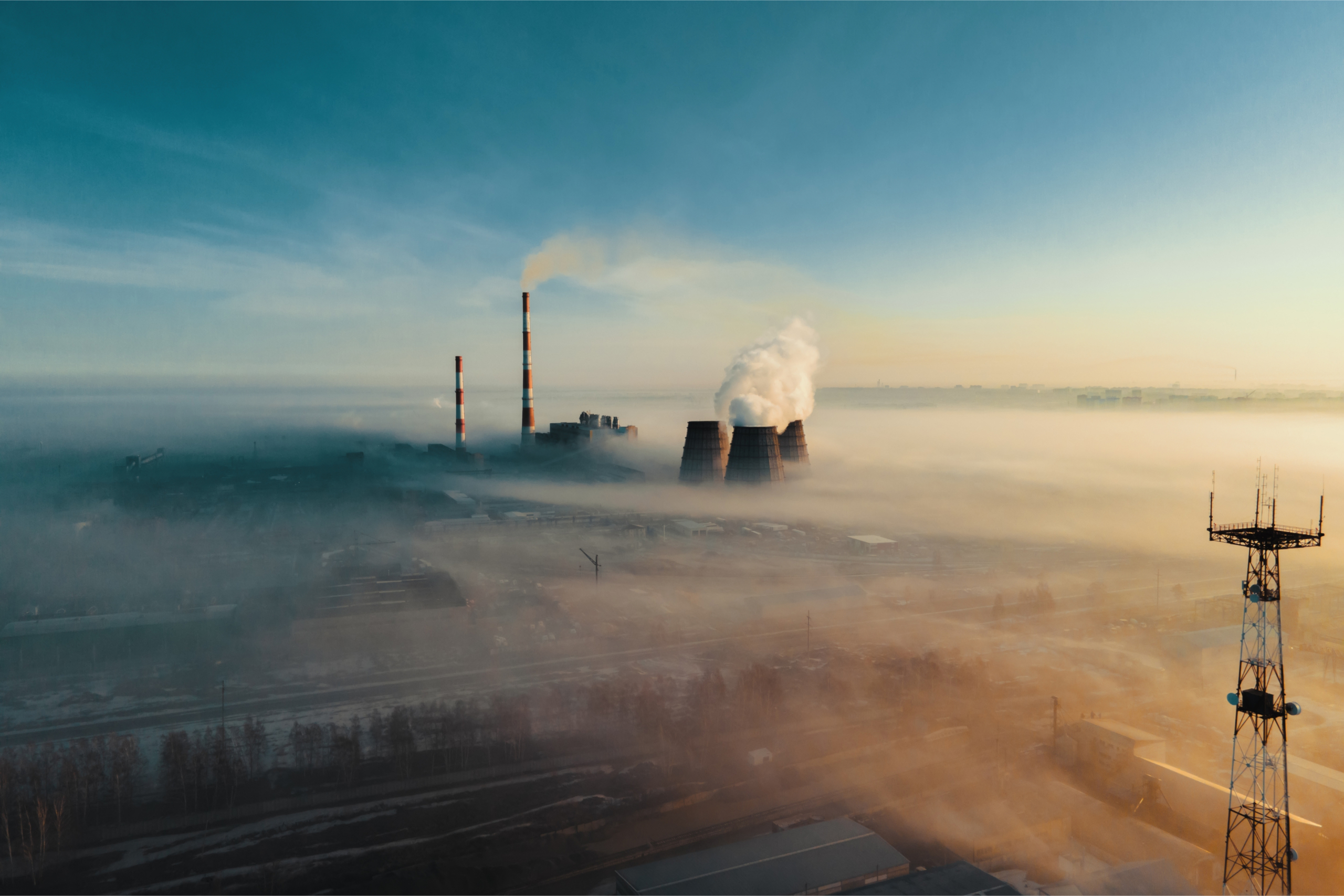 Chimneys and cooling towers above clouds